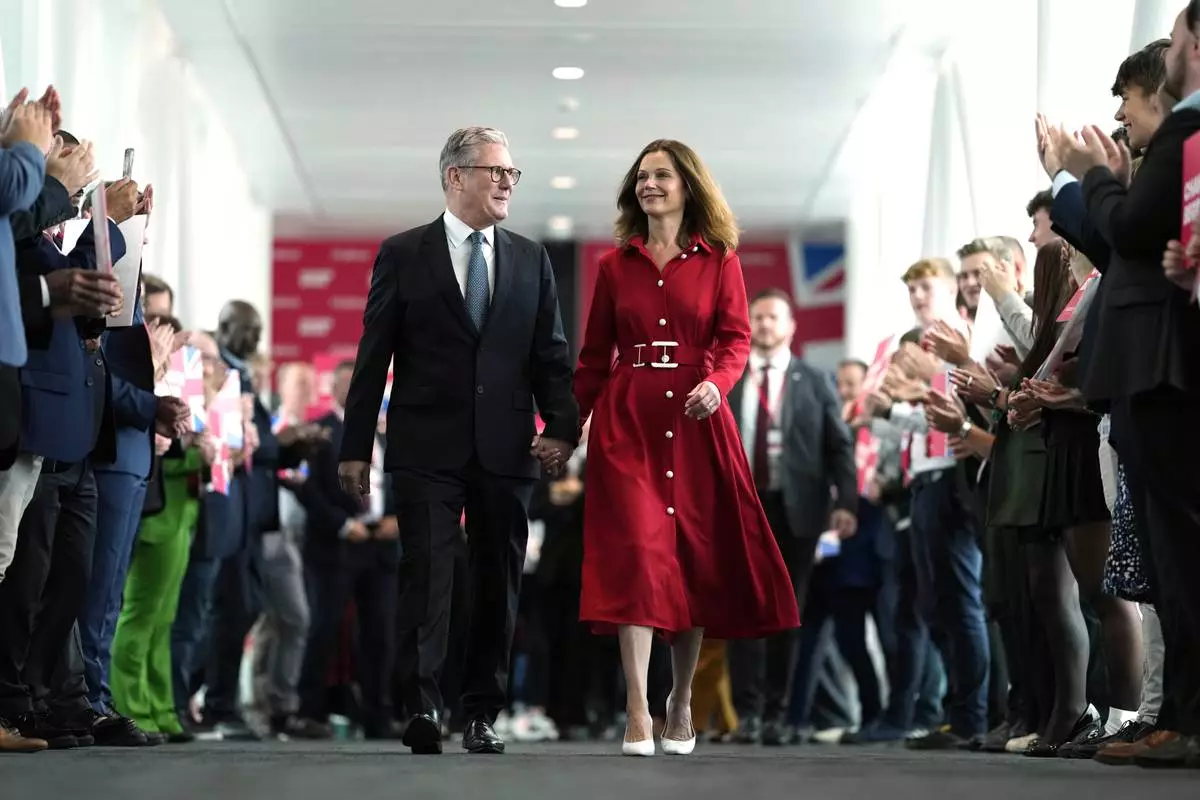 FILE - Britain's Prime Minister Keir Starmer and his wife, Victoria, arrive at the Labour Party Conference in Liverpool, England, Sept. 24, 2024. (AP Photo/Jon Super, File)