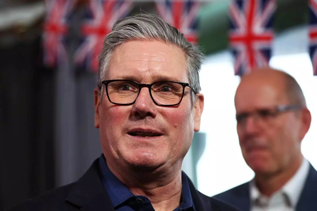 FILE - Britain's Prime Minister Keir Starmer talks with members of the audience after delivering a speech at Horntye Park Sports Complex in St Leonards-on-Sea, East Sussex, England, Feb. 5, 2026. (Peter Nicholls/Pool Photo via AP, File)