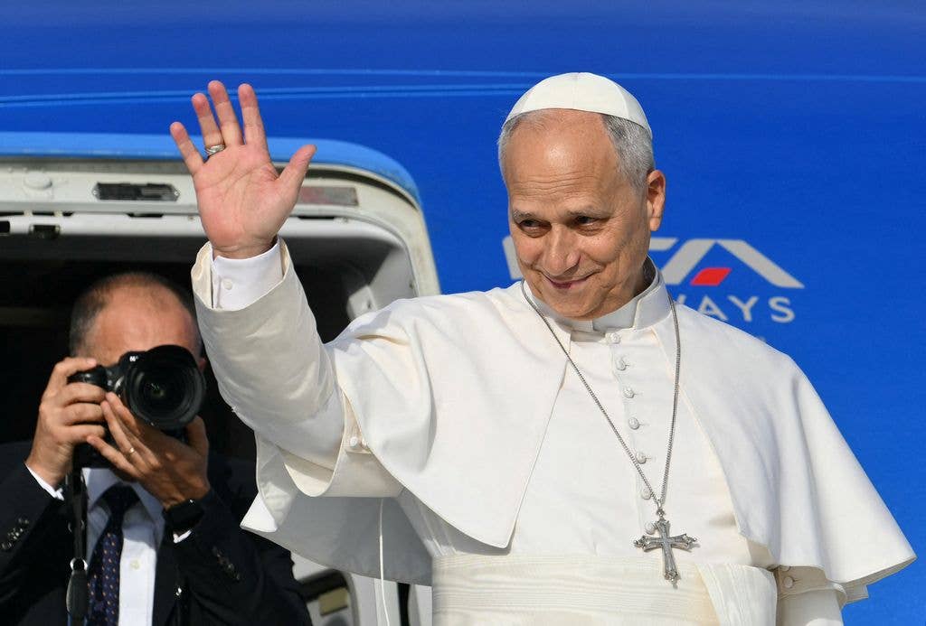Pope Leo XIV salutes as he prepares to board his plane heading to Madrid 