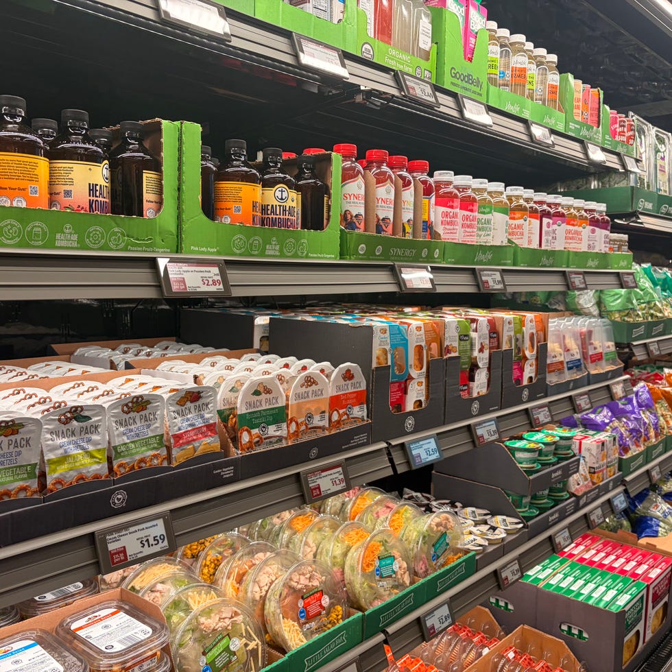 Grocery store shelves with snacks, beverages, and packaged foods.