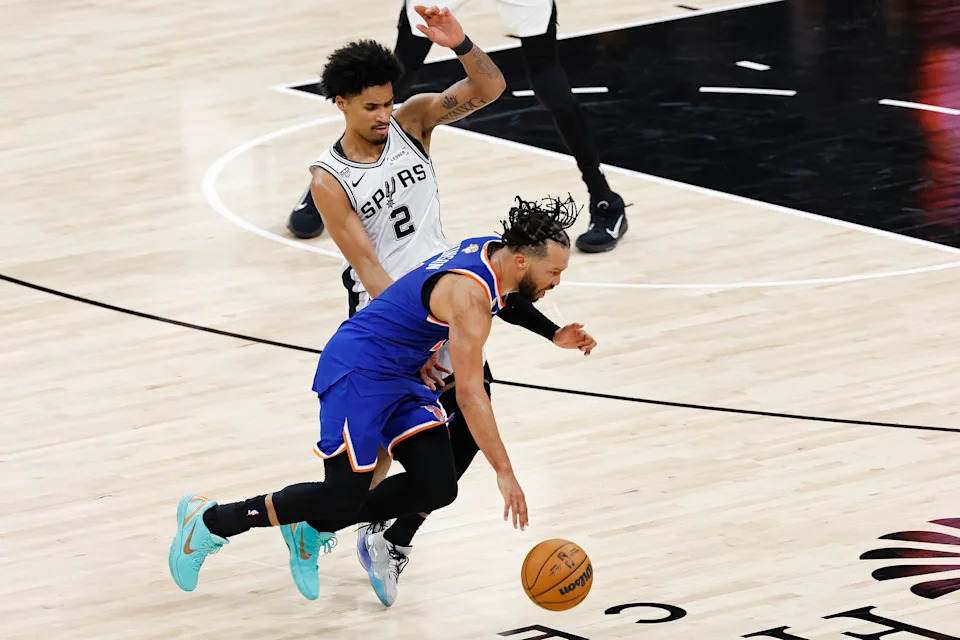 Jalen Brunson #11 of the New York Knicks dribbles against Dylan Harper #2 of the San Antonio Spurs during the third quarter in Game Five.
