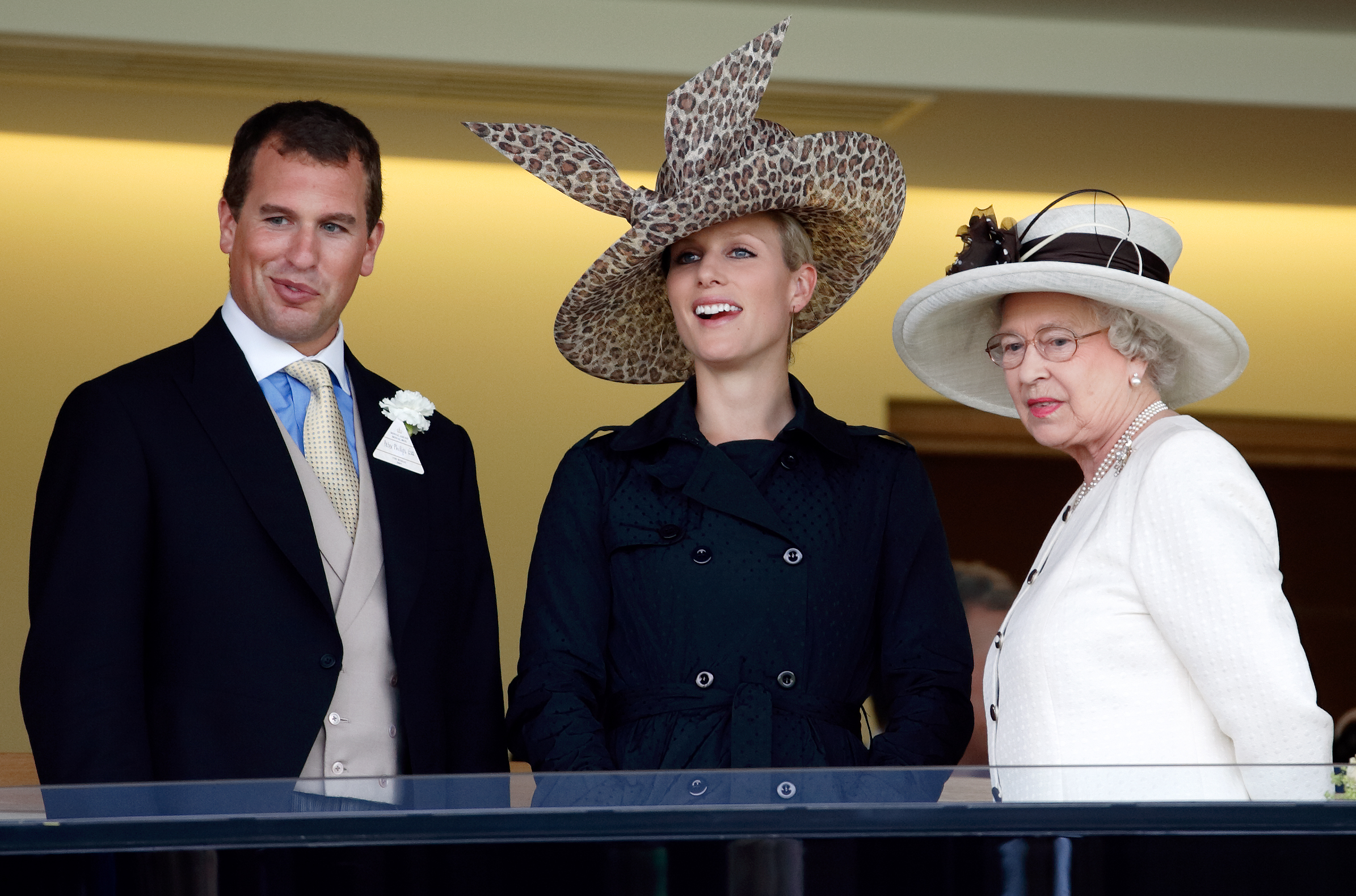 Queen Elizabeth standing with Peter Phillips and Zara Tindall at Royal Ascot