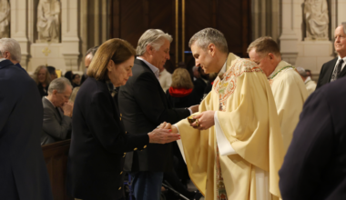 Archbishop Ronald Hicks (center) distributes communion during a May 14, 2026 Mass at St. Patrick’s Cathedral.