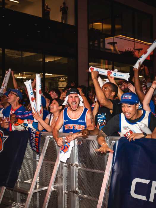 group of people wearing Knicks basketball jerseys and gear