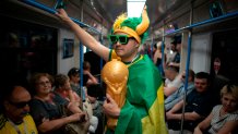 A fan wrapped in a Brazilian flag travels on the subway to Spartak Stadium to attend the group E match between Serbia and Brazil, at the 2018 soccer World Cup in Moscow, Russia, Wednesday, June 27, 2018. (AP Photo/Victor R. Caivano, File)