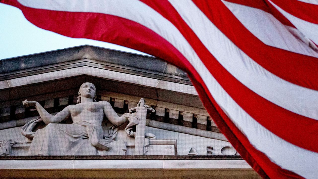 An American flag flies outside the Department of Justice in Washington. (AP Photo/Andrew Harnik, File)