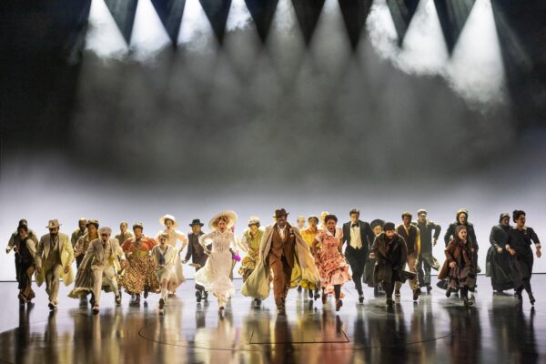 The cast appears during a performance of 