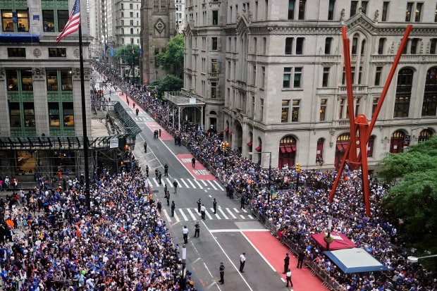 Crowds fill the sidewalks waiting for the start of the NBA Champion New York Knicks ticker-tape parade on Broadway, in New York's "Canyon of Heroes," Thursday, June 18, 2026. (AP Photo/Richard Drew)