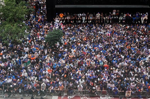 Crowds fill the sidewalks waiting for the start of the NBA Champion New York Knicks ticker-tape parade on Broadway, in New York's "Canyon of Heroes," Thursday, June 18, 2026. (AP Photo/Richard Drew)