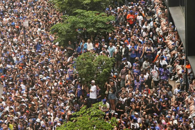 Crowds fill the sidewalks waiting for the start of the NBA Champion New York Knicks ticker-tape parade on Broadway, in New York's "Canyon of Heroes," Thursday, June 18, 2026. (AP Photo/Richard Drew)