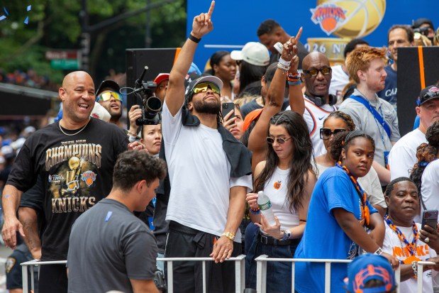From left, Rick Brunson, New York Knicks guard Jalen Brunson and wife Ali Brunson are in the NBA championship ticker-tape parade on Broadway, in New York's "Canyon of Heroes," Thursday, June 18, 2026. At right is actor Tracy Morgan. (AP Photo/Ted Shaffrey)