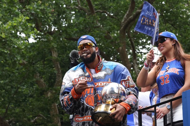 New York Knicks player Karl-Anthony Towns celebrates the team's NBA championship during a ticker-tape parade down Lower Manhattan's "Canyon of Heroes" on Broadway, Thursday, June 18, 2026 in New York. This was the Knicks' first NBA championship in 53 years. (Jason DeCrow/Alliance for Downtown New York via AP Content Services)