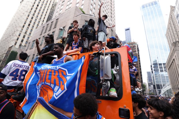 New York Knicks fans celebrate the team's NBA championship following a ticker-tape parade down Lower Manhattan's "Canyon of Heroes" on Broadway, Thursday, June 18, 2026 in New York. This was the Knicks' first NBA championship in 53 years. (Jason DeCrow/Alliance for Downtown New York via AP Content Services)