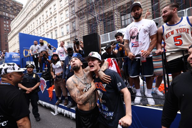 New York Knicks players Jose Alvarado, left, and Tyler Kolek celebrate the team's NBA championship during a ticker-tape parade down Lower Manhattan's "Canyon of Heroes" on Broadway, Thursday, June 18, 2026 in New York. This was the Knicks' first NBA championship in 53 years. (Jason DeCrow/Alliance for Downtown New York via AP Content Services)