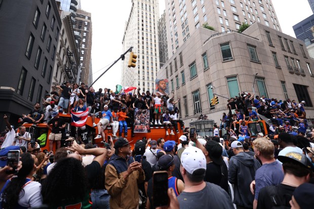 New York Knicks fans celebrate the team's NBA championship following a ticker-tape parade down Lower Manhattan's "Canyon of Heroes" on Broadway, Thursday, June 18, 2026 in New York. This was the Knicks' first NBA championship in 53 years. (Jason DeCrow/Alliance for Downtown New York via AP Content Services)