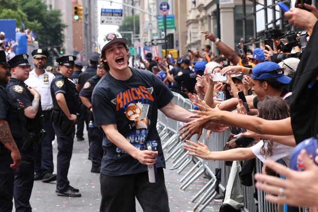 New York Knicks player Tyler Kolek celebrates the team's NBA championship during a ticker-tape parade down Lower Manhattan's "Canyon of Heroes" on Broadway, Thursday, June 18, 2026 in New York. This was the Knicks' first NBA championship in 53 years. (Jason DeCrow/Alliance for Downtown New York via AP Content Services)