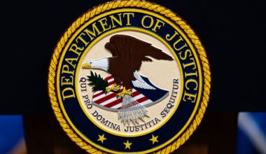 The U.S. Department of Justice logo is seen on a podium before a news conference, May 4, 2026, in Washington. (AP Photo/Julia Demaree Nikhinson)