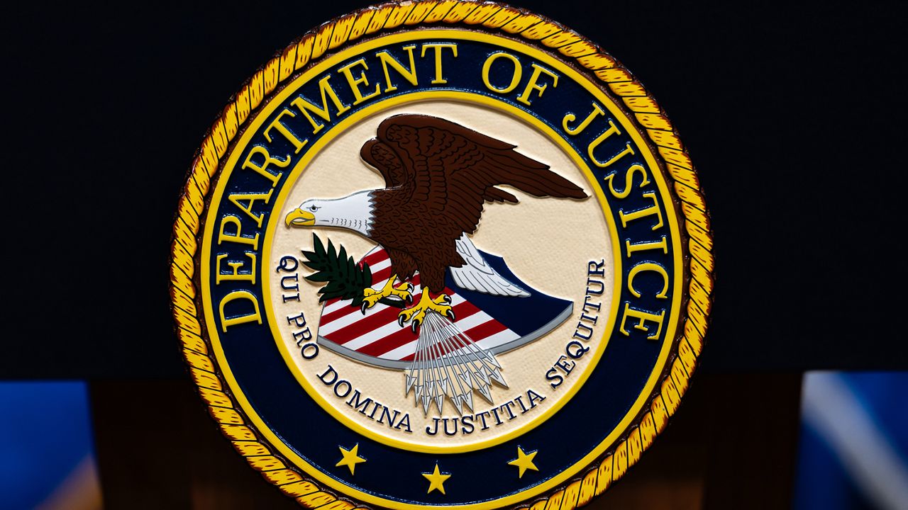 The U.S. Department of Justice logo is seen on a podium before a news conference, May 4, 2026, in Washington. (AP Photo/Julia Demaree Nikhinson)
