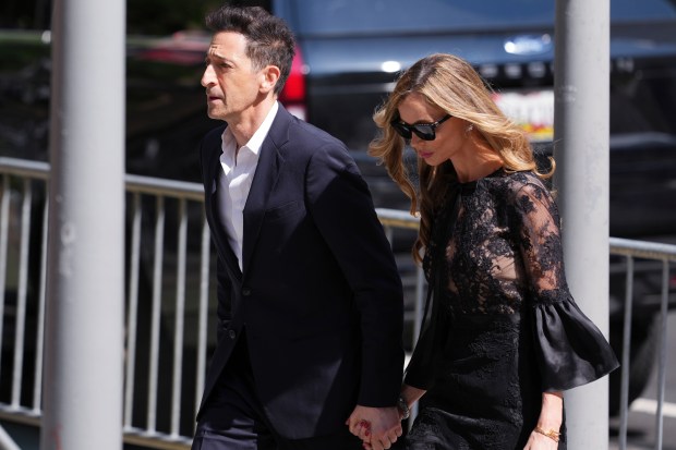 Adrien Brody and Georgina Chapman arrive at the funeral services for Clive Davis at Central Synagogue in New York, Monday, June 29, 2026. (AP Photo/Adam Gray)