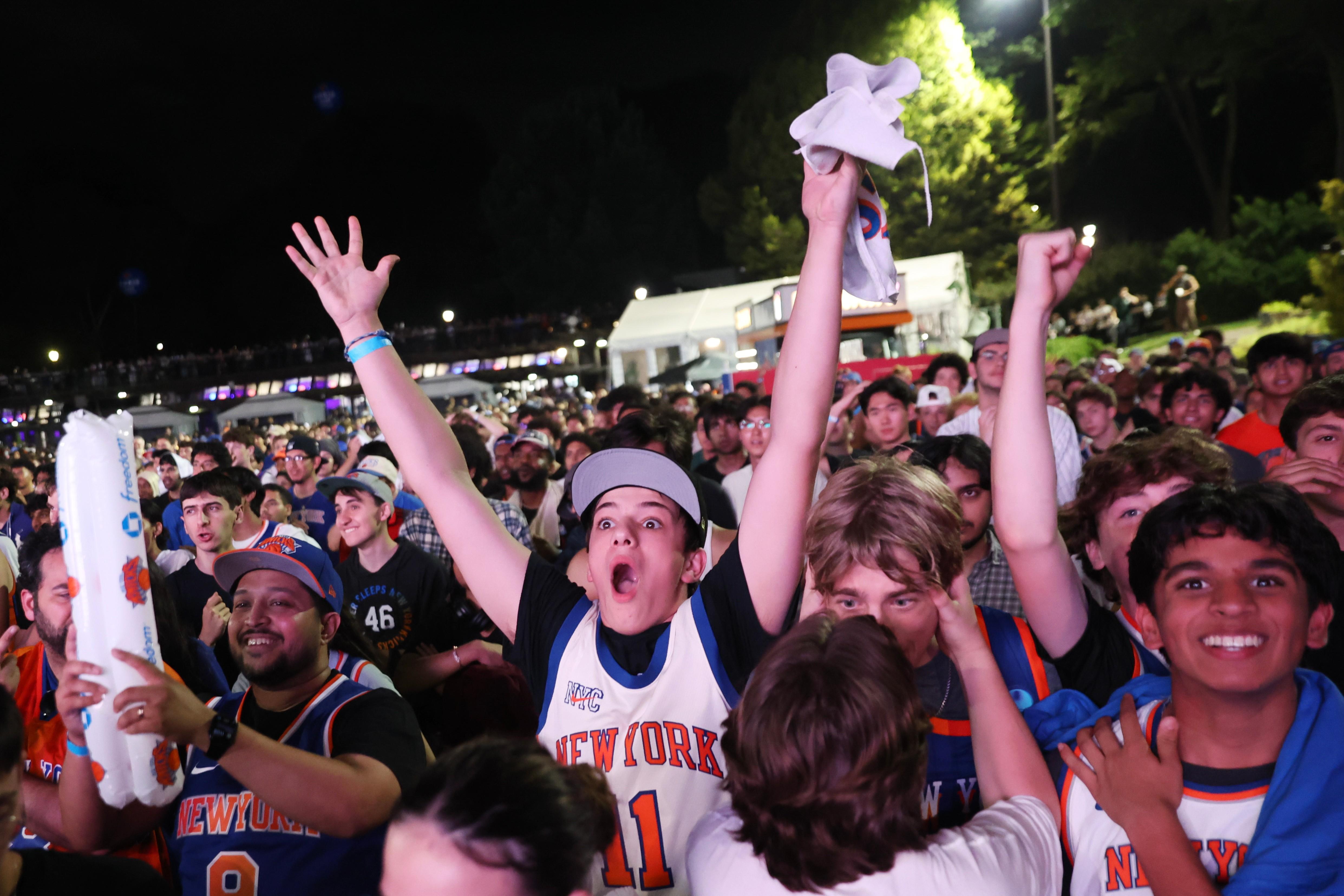 New York Knicks fans react during a watch party inside...
