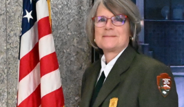 A woman wearing a National Park Service uniform and glasses.