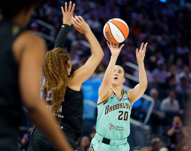 New York Liberty's Sabrina Ionescu (20) scores a 3-point basket against Golden State Valkyries' Veronica Burton (22) in the third quarter at the Chase Center in San Francisco, Calif., on Sunday, June 28, 2026. (Nhat V. Meyer/Bay Area News Group)
