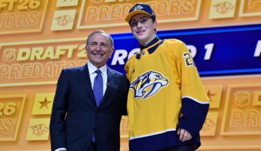 Thomas Bleyl, right, stands with NHL Commissioner Gary Bettman after being drafted by the Nashville Predators during the NHL hockey draft Friday, June 26, 2026, in Buffalo, N.Y. (AP Photo/Adrian Kraus)