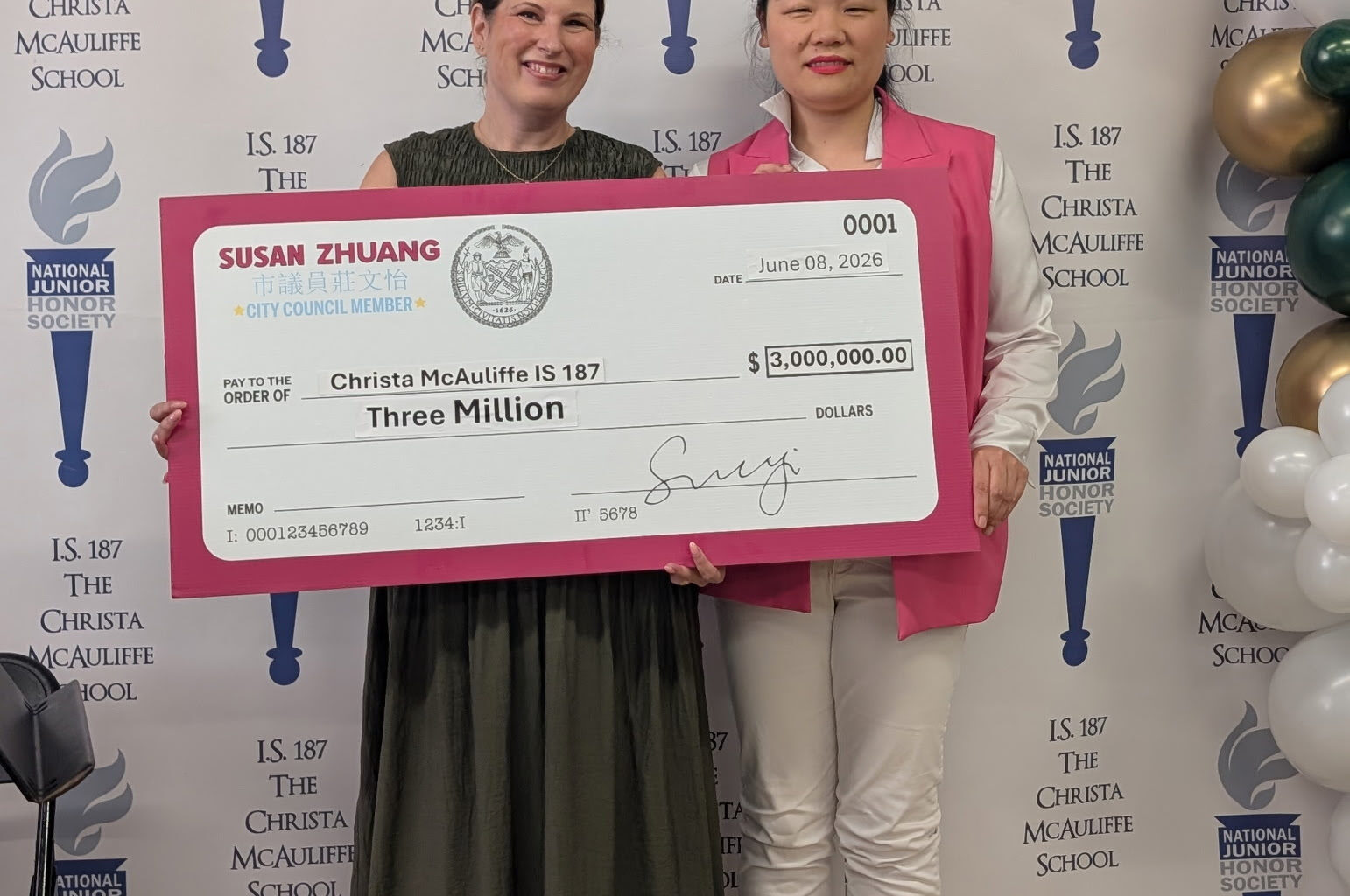 Mrs. Mina Sadiki, principal of the Christa McAuliffe School, left, receives a ceremonial check on June 8 from Councilmember Susan Zhuang. Photo: Office of Councilmember Zhuang