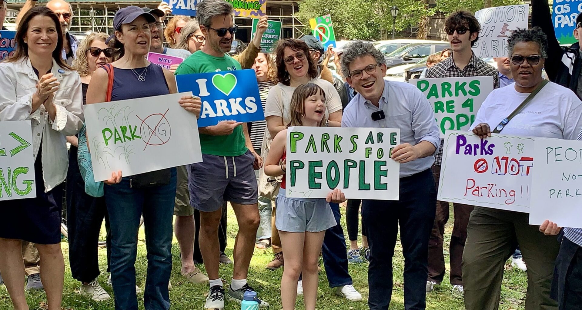Brooklyn officials and community members gathered Sunday in Columbus Park to demand the eviction of judges from a private parking lot built on parkland. Shown center: Councilmember Lincoln Restler with P.S. 261 student Olivia. Photo: Mary Frost/Brooklyn Eagle