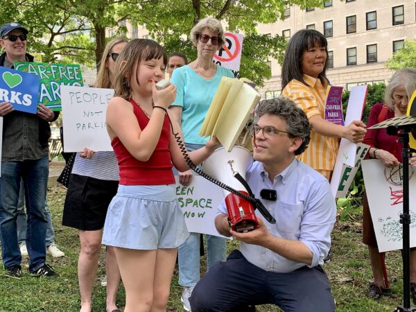 Octavia, a student at P.S. 261, speaks out while Councilmember Lincoln Restler assists with the megaphone. Photo: Mary Frost/Brooklyn Eagle