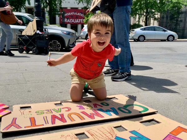 Hank, age 4, helps with the signage. Photo: Mary Frost/Brooklyn Eagle