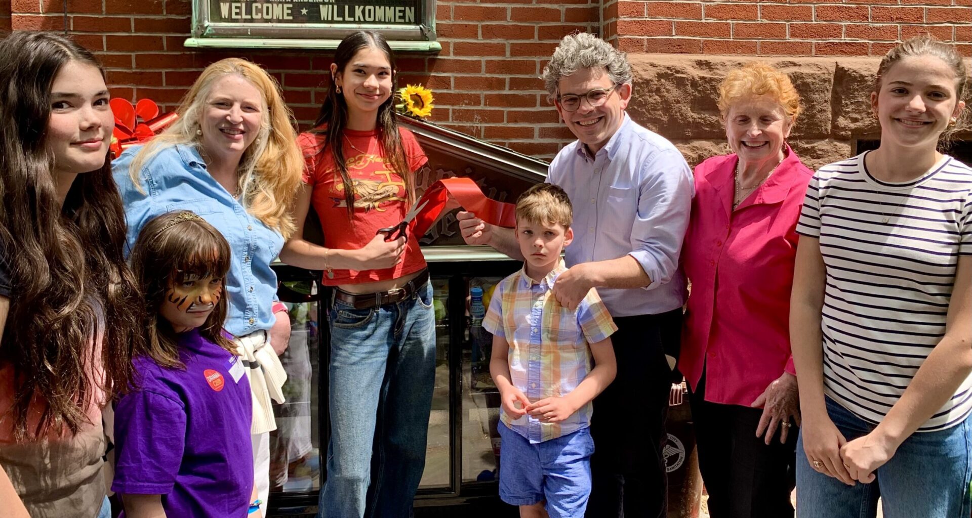 Young volunteers snipped the ribbon on Sunday to celebrate a new Brooklyn Heights Community Fridge. Photo: Mary Frost/Brooklyn Eagle