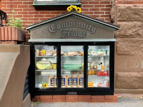 The new Brooklyn Heights Community Fridge began to fill up with food on Sunday. Photo: Mary Frost/Brooklyn Eagle