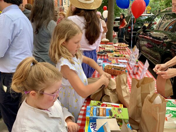Young volunteers make and wrap sandwiches to stock the Community Fridge. Photo: Mary Frost/Brooklyn Eagle