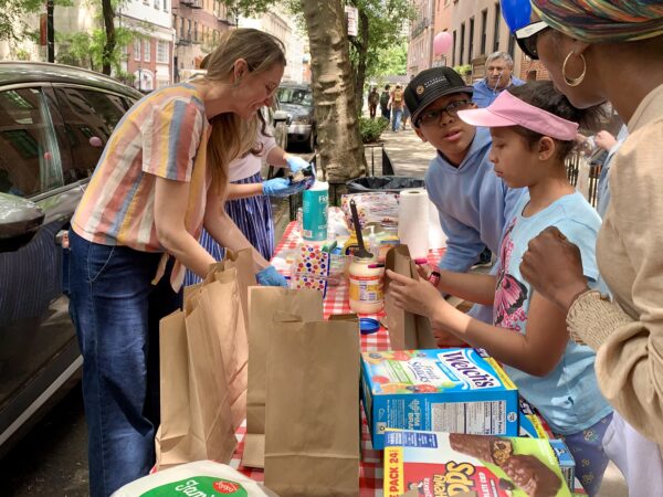 Volunteers pack goodies in with the sandwiches. Photo: Mary Frost/Brooklyn Eagle