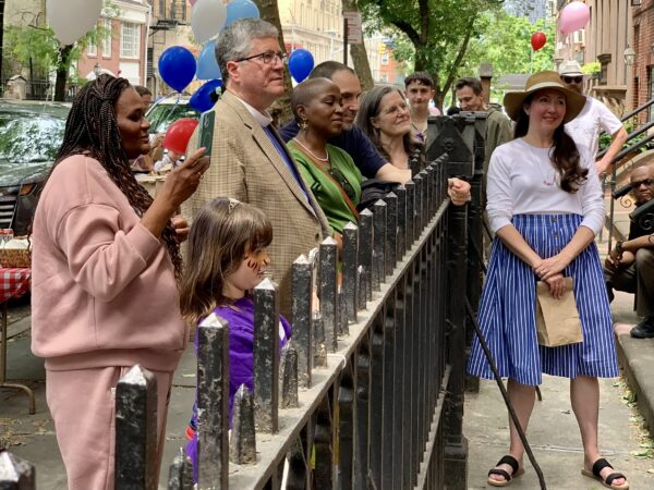 Neighbors watch as the ribbon is cut for the new Brooklyn Heights Community Fridge. Photo: Mary Frost/Brooklyn Eagle