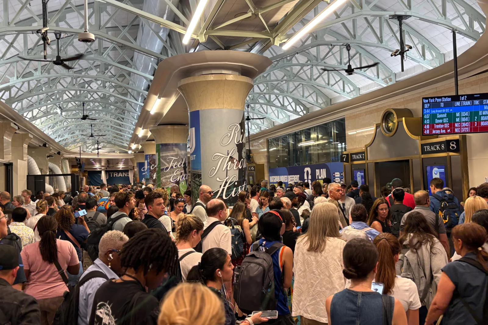 Commuters wait at a packed New York Penn Station as trains are delayed and cancelled on June 11, 2026 in New York.
