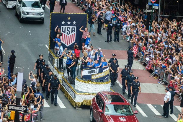 NYPD officers keep security around a float during the U.S. Women's National Soccer Team's ticker tape parade after they won the 2019 World Cup in Lower Manhattan on Wednesday, July 10, 2019. (Jeff Bachner for New York Daily News)