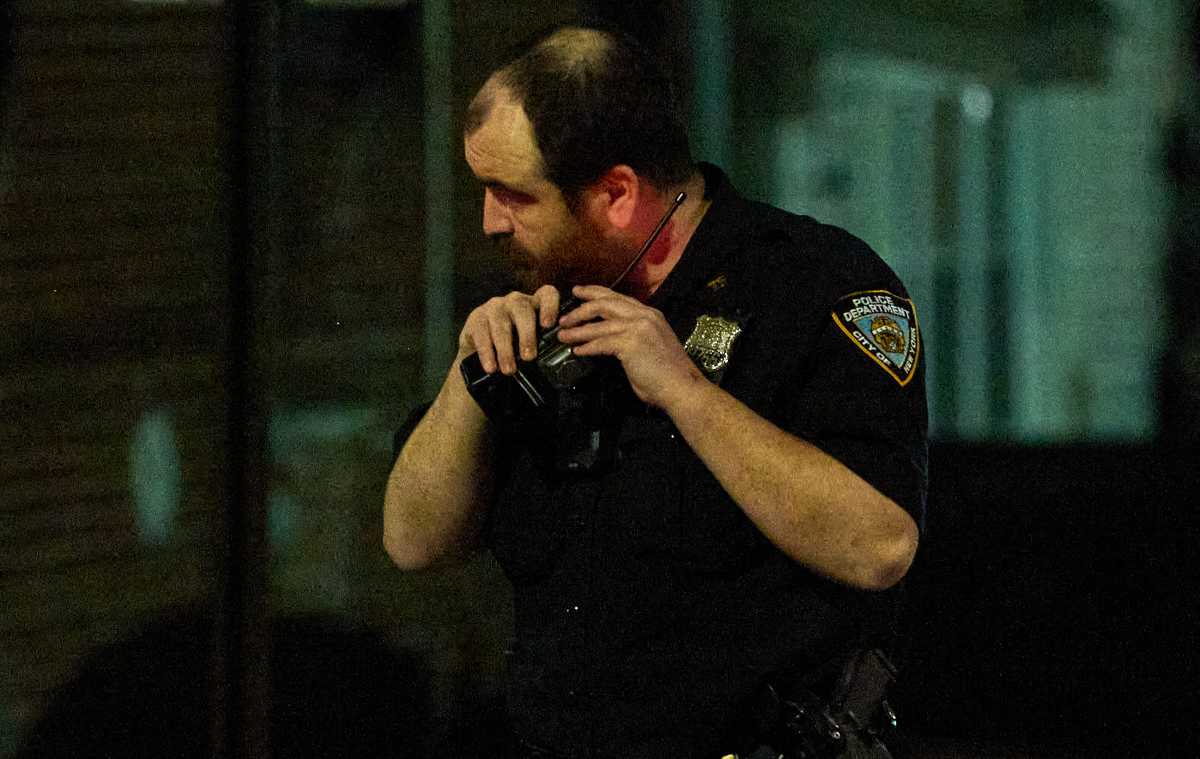 Police radio held by officer in Queens