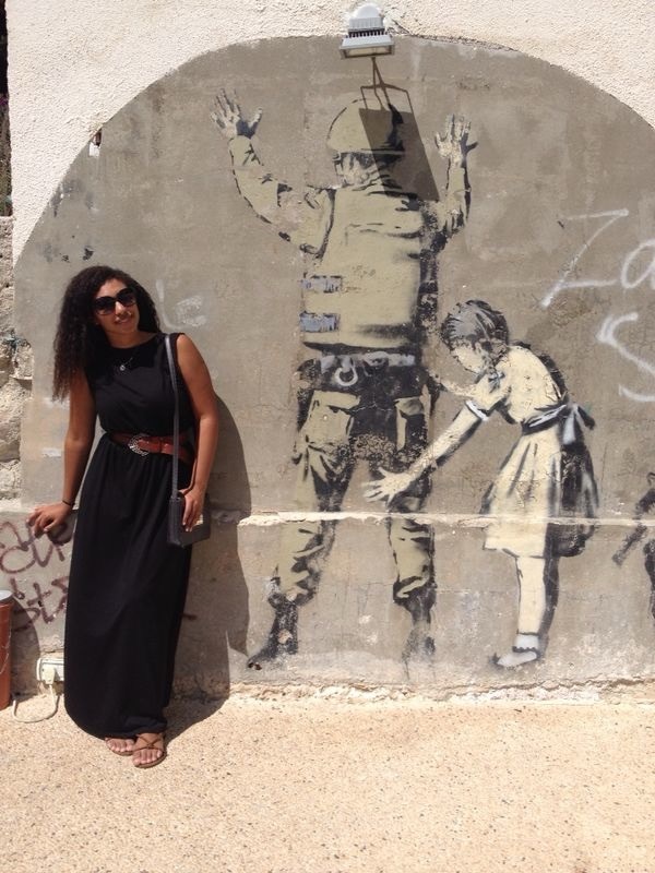 Avila Chevalier visited the West Bank in 2014. She’s pictured here with a Banksy in Bethlehem.