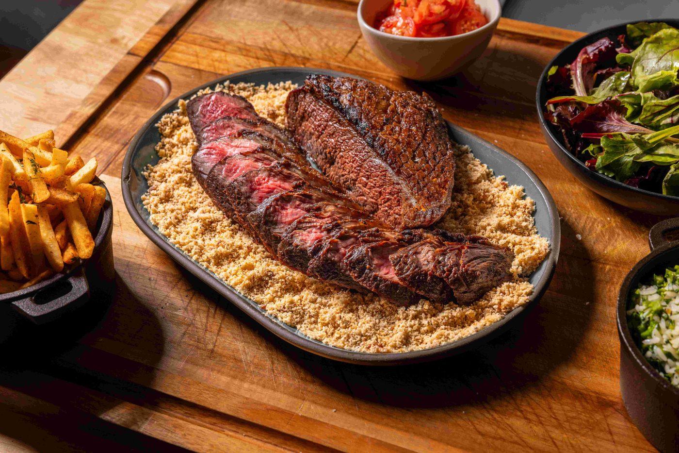 A meat dish on a shallow bowl of rice.