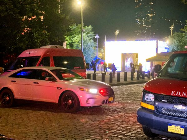 Police and fire vehicles blocked Water Street after the NYPD drone crash. The adidas World Cup Fan Zone can be seen, brightly lit, in the background. Photo: Mary Frost/Brooklyn Eagle