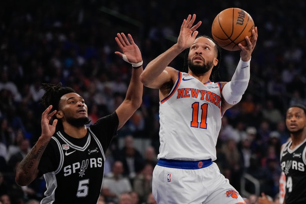 New York Knicks guard Jalen Brunson (11) shoots past San Antonio Spurs guard Stephon Castle...