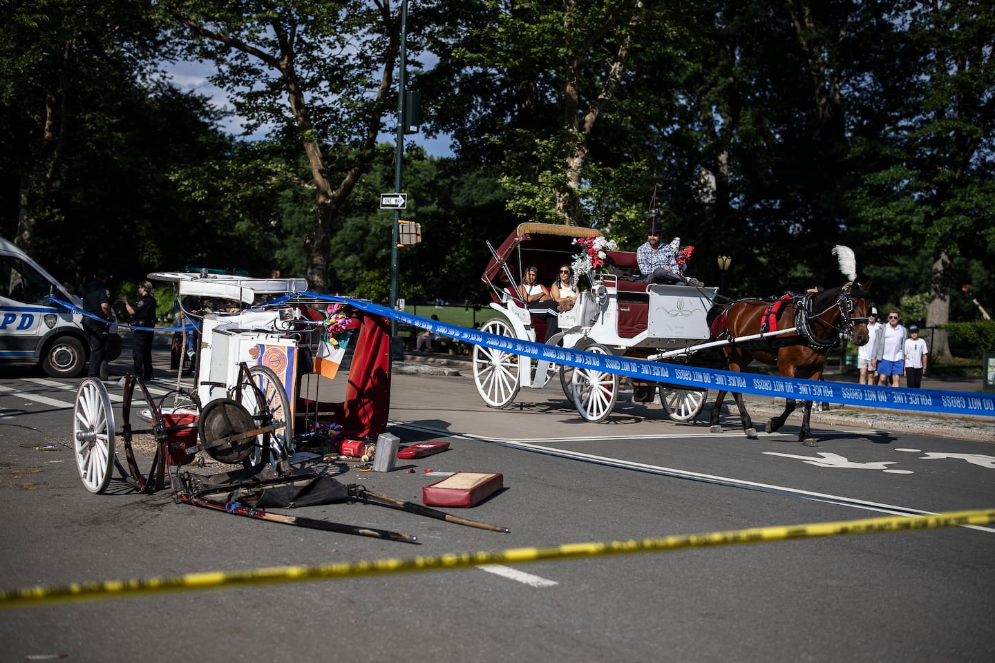 The wreckage of a horse-drawn carriage lies on West Drive in New York's Central Park after a horse went out of control and collided with another carriage before toppling over, according to the Central Park Conservancy, on Wednesday, June 17, 2026.
