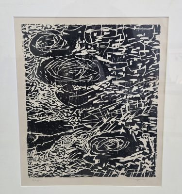 Framed black-and-white print artwork featuring dense, energetic white linework and nest-like forms on a dark background, signed by the artist.