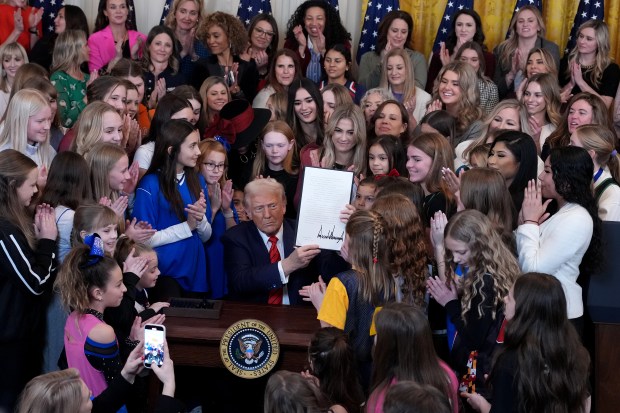 President Donald Trump, joined by female athletes, signs the "No Men in Women's Sports" executive order in the East Room at the White House on Feb. 5, 2025 in Washington, DC. (Photo by Andrew Harnik/Getty Images)