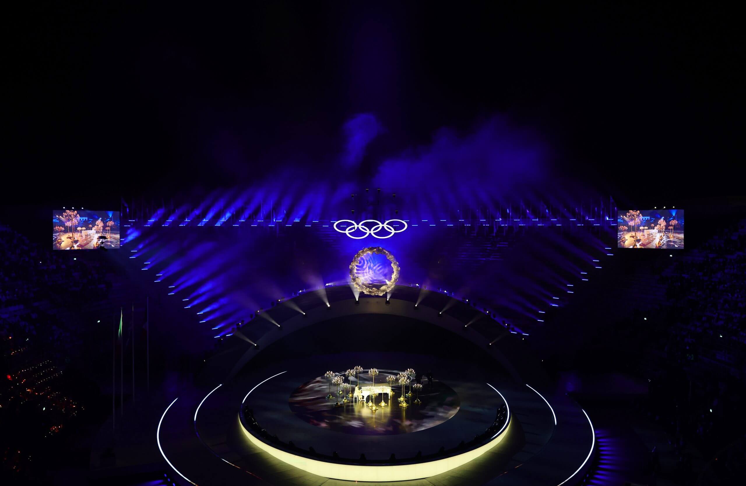 A nighttime aerial view of a stage at the 2026 Winter Olympics.