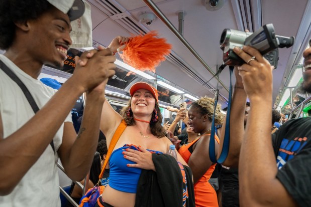 NEW YORK, NEW YORK - JUNE 13: New Yorkers celebrate on an A subway train after the Knicks win Game 5 of the NBA finals to secure the championship on June 13, 2026 in New York City. The Knicks closed out the San Antonio Spurs to win their first title since 1973. (Photo by Jeremy Weine/Getty Images)