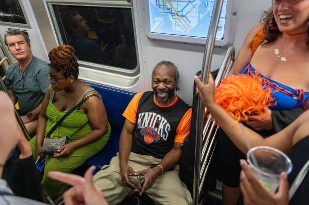 NEW YORK, NEW YORK - JUNE 13: New Yorkers celebrate on an A subway train after the Knicks win Game 5 of the NBA finals to secure the championship on June 13, 2026 in New York City. The Knicks closed out the San Antonio Spurs to win their first title since 1973. (Photo by Jeremy Weine/Getty Images)