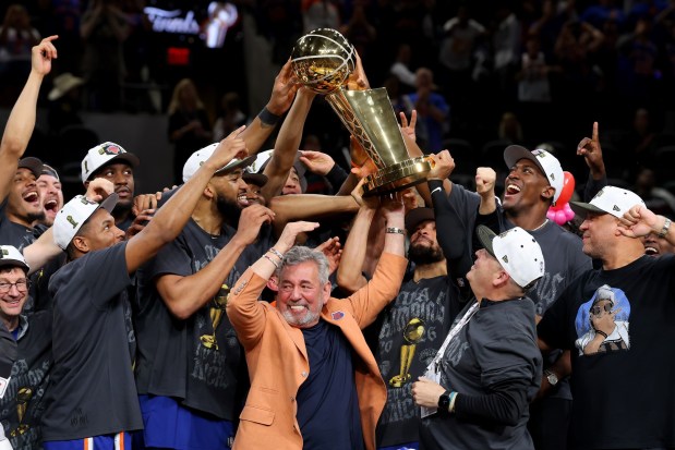 New York Knicks owner James Dolan and president Leon Rose lift the Larry O'Brien Championship Trophy after their team defeated the San Antonio Spurs in Game Five of the 2026 NBA Finals at Frost Bank Center on June 13, 2026 in San Antonio, Texas. (Photo by Gregory Shamus/Getty Images)